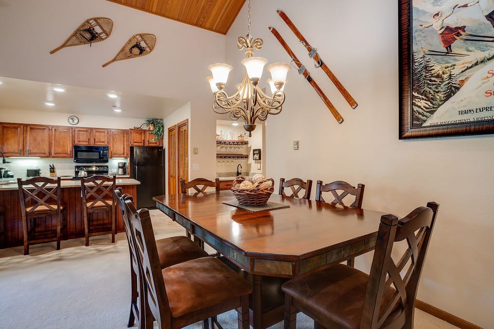 Gather around this rustic dining table where your group can share memorable meals beneath charming vintage skis and snowshoes.