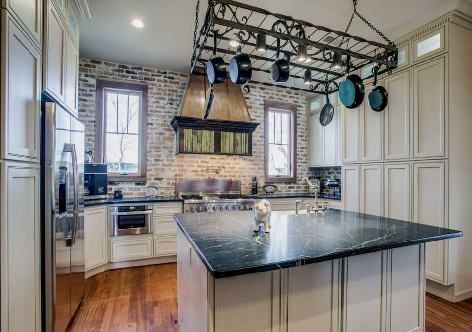 Dream Kitchen w/ commercial range / oven, soapstone countertops, excess storage.