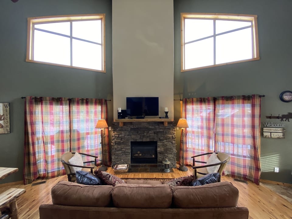 Main living room w/ beautiful views of Lake Granby. Kitchen/dining to the left
