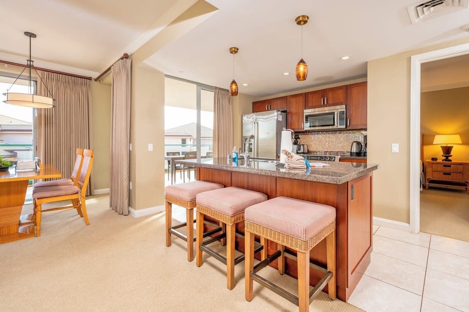 Island kitchen and dining area with balcony light and cozy comfort.