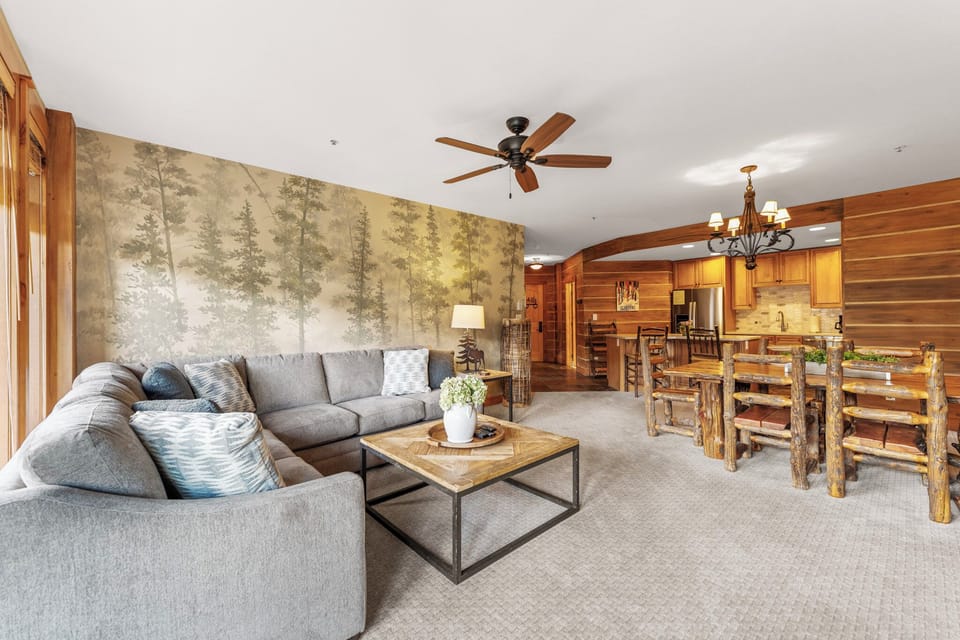 Living area offering cozy furnishings, gas fireplace and private balcony access.