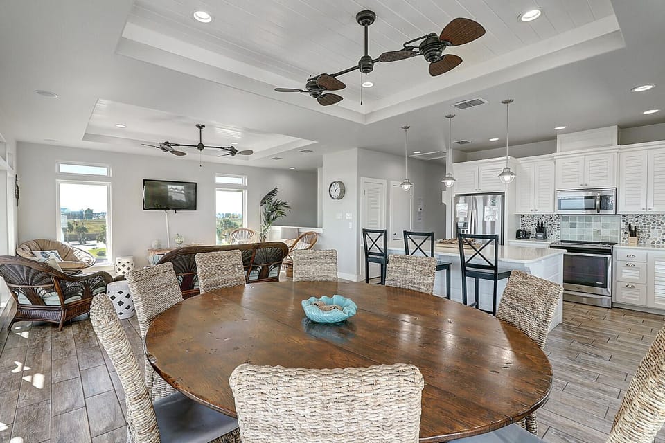 Gather around this stunning round table for memorable meals with family and friends in your open-concept space.