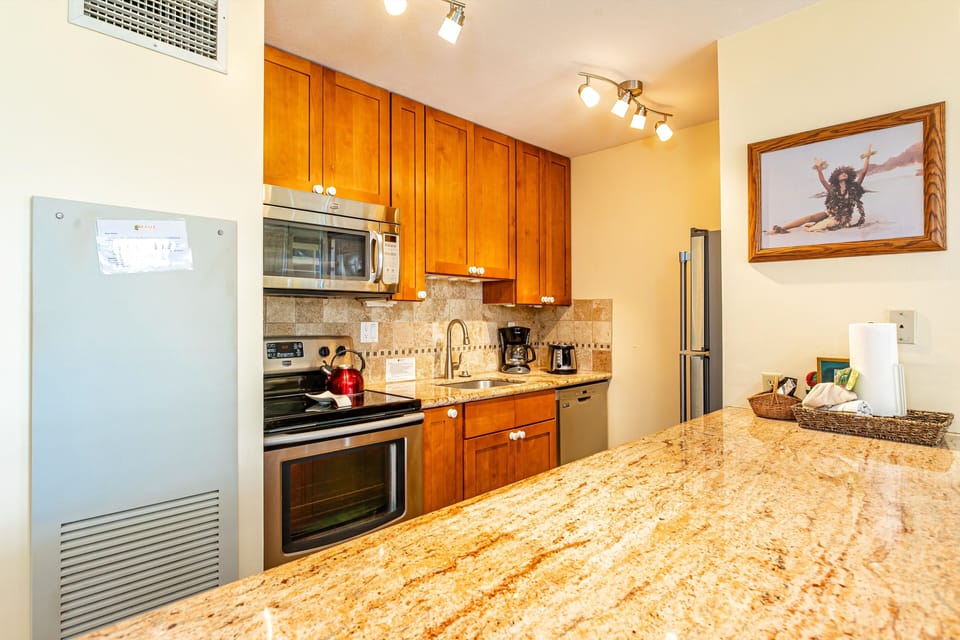 Your fully-equipped kitchen features warm wood cabinetry, granite countertops, and modern appliances, making it easy to prepare home-cooked meals during your stay.