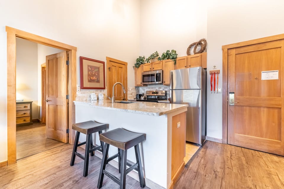 Your fully equipped kitchen features granite counters and stainless appliances, perfect for preparing meals during your mountain getaway.