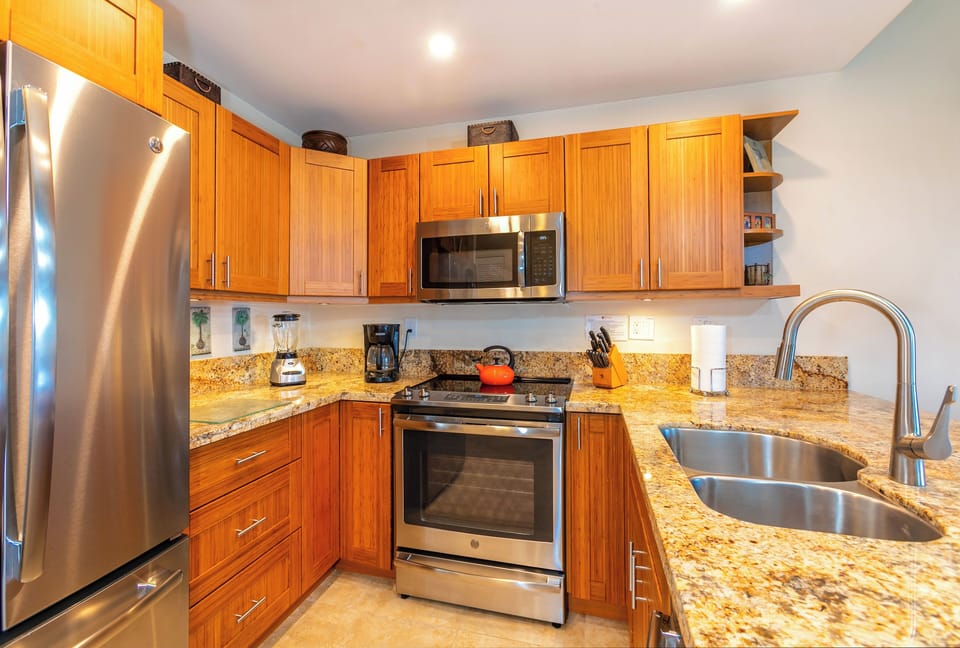 Your gourmet kitchen is fully equipped with stainless steel appliances, granite countertops, and warm wooden cabinetry—perfect for whipping up meals after a day of adventures.