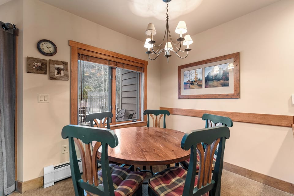 Gather around this cozy dining table where warm wood tones and mountain views create the perfect setting for your memorable meals together.