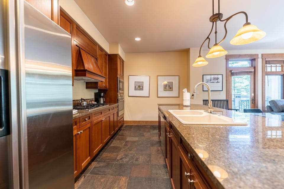 Your gourmet kitchen features rich cherry cabinets, granite countertops, and stainless steel appliances, perfect for creating memorable meals together.