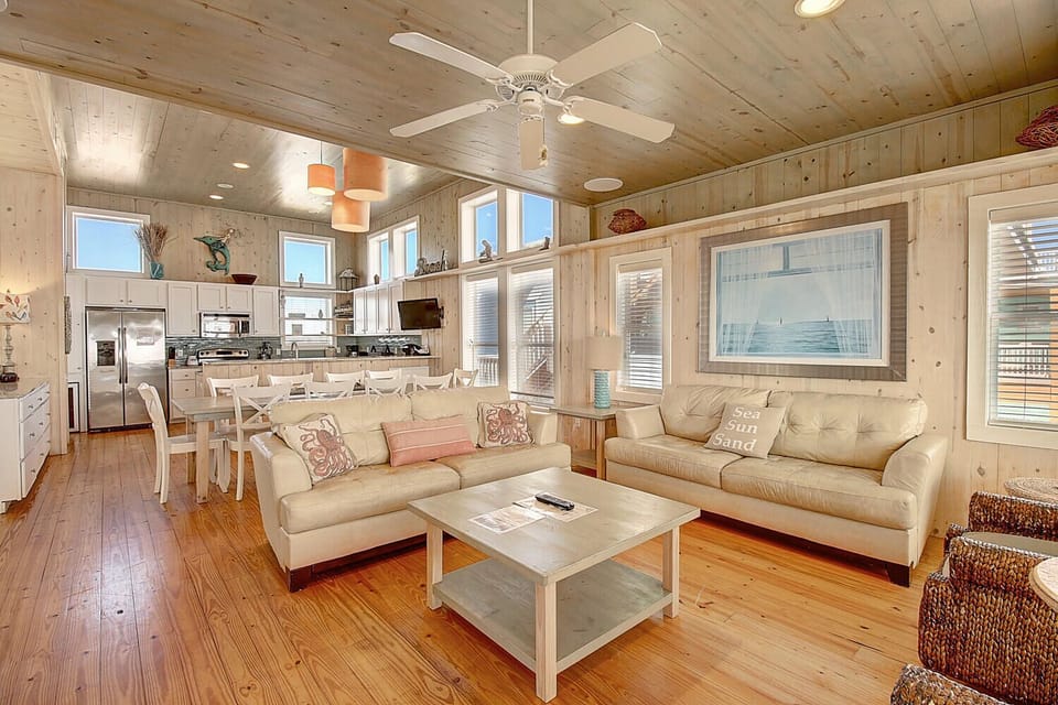 Relax in your bright, beachy living space with comfy seating and stunning water views through large windows.