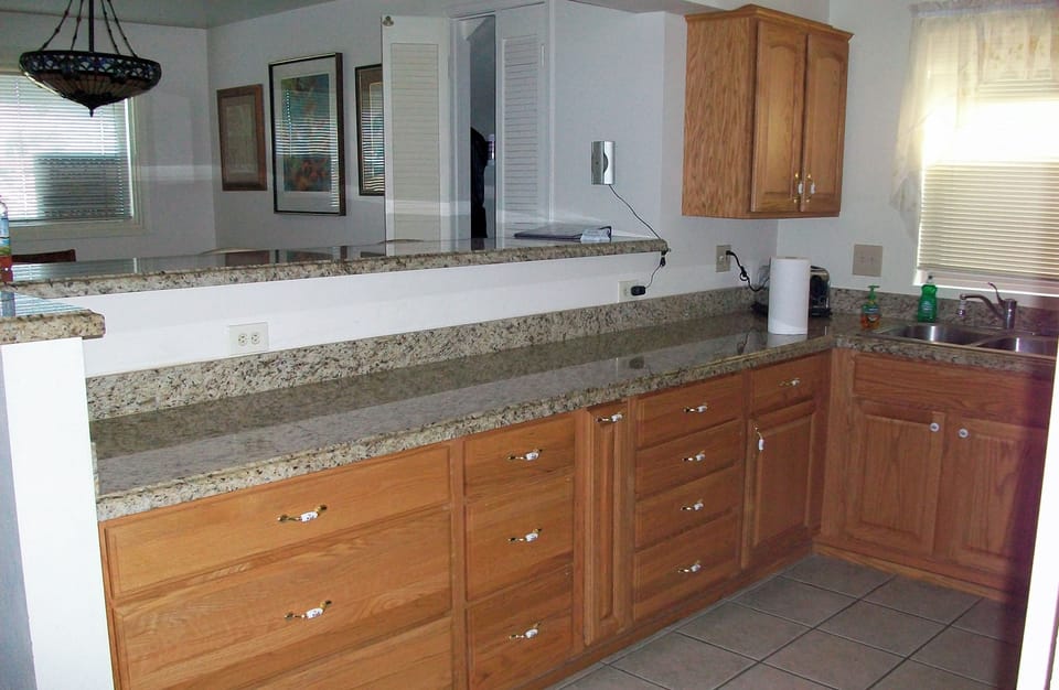 Another view of kitchen showing expansive granite countertop.