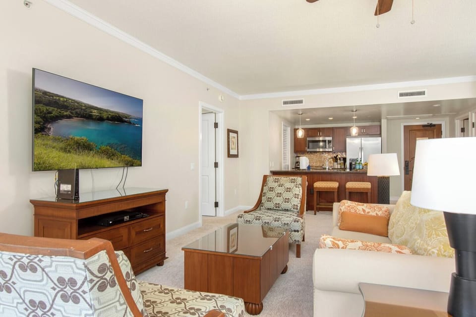 Spacious island suite with modern kitchen, cozy seating, and entertainment.