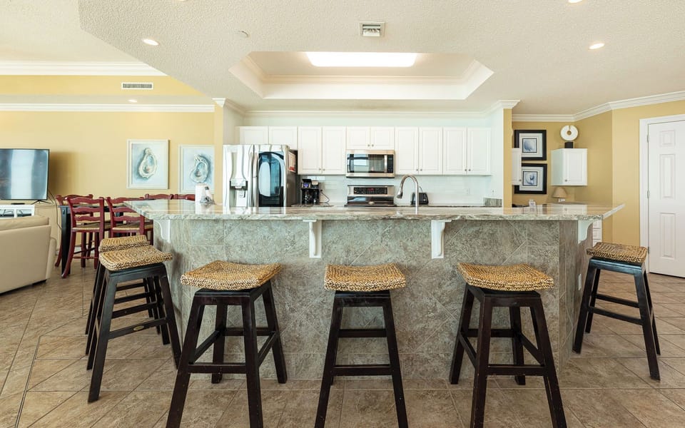 Gather around the breakfast bar on woven stools and share stories while coffee brews nearby