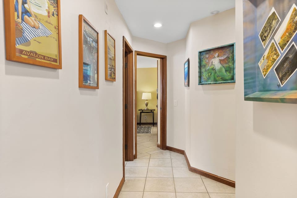 Step through your bright, art-filled hallway connecting you to your private bedroom retreat—a warm, welcoming transition to your home away from home.