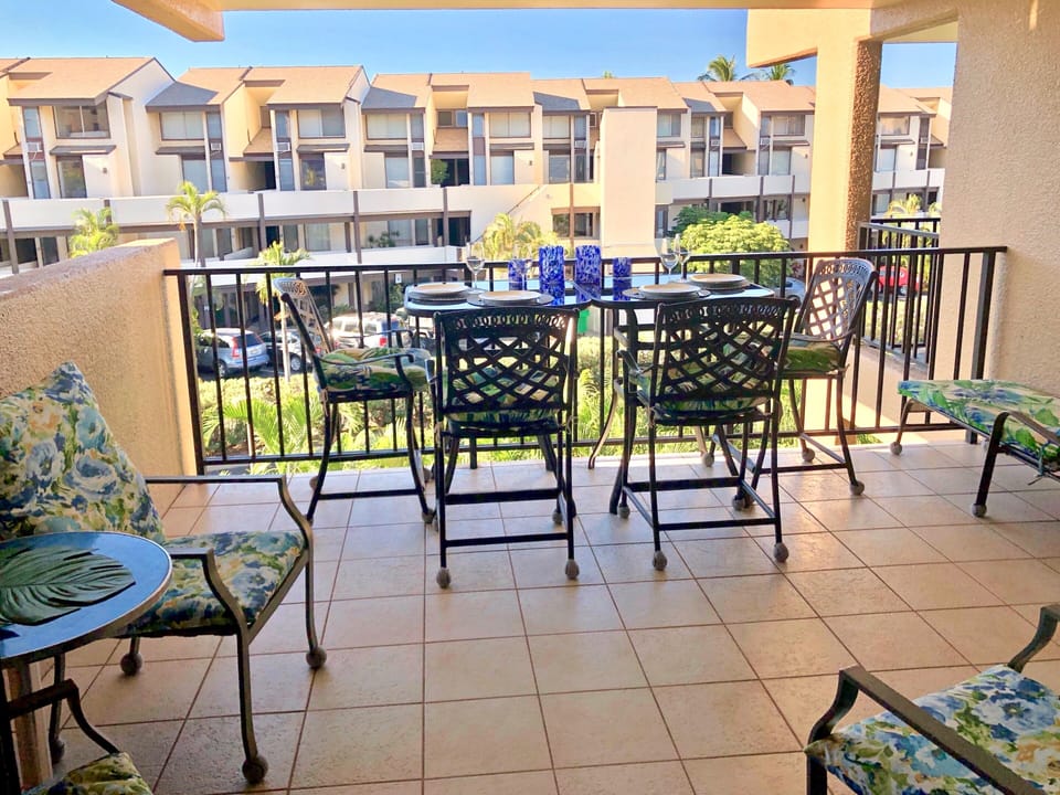 Your private balcony invites you to relax with morning coffee or evening drinks, overlooking tropical gardens and the neighboring resort-style buildings. The comfortable seating and outdoor dining setup make it perfect for unwinding in the warm breeze.