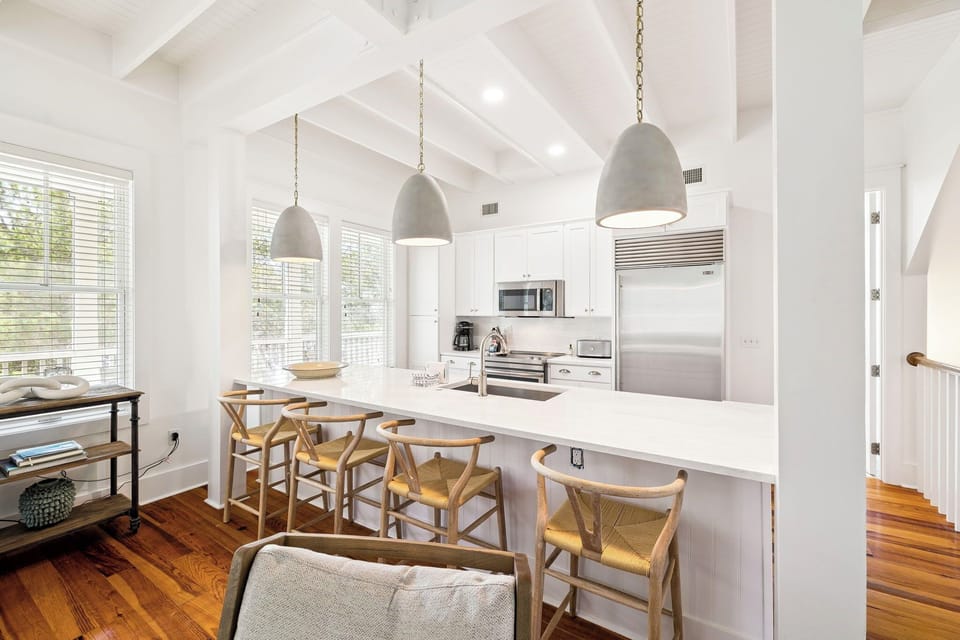 Gather around your bright, airy kitchen island where exposed beams and natural light create the perfect space for cooking and connecting.