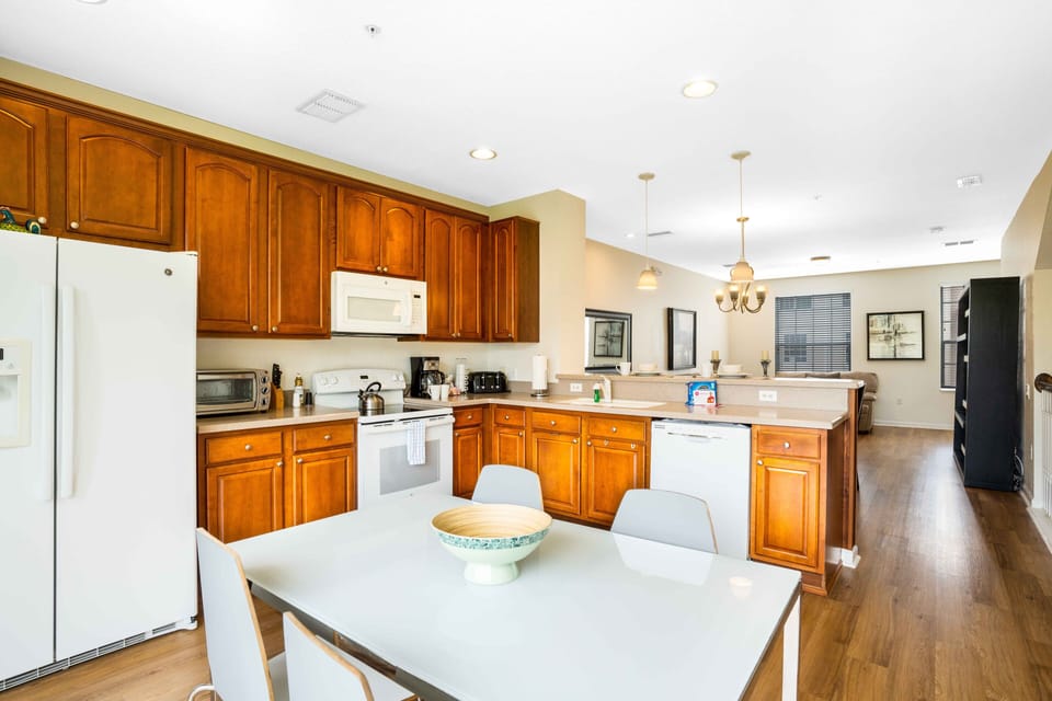 The Kitchen- adorned with rich wooden cabinets – where classic charm meets modern convenience, creating a culinary sanctuary that exudes warmth and sophistication.