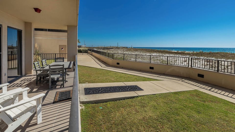 Relax on the spacious patio with comfortable seating and enjoy the fresh air and views of the tranquil beach