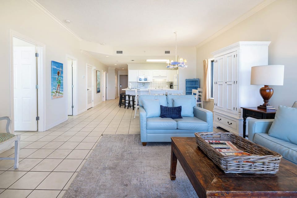 Unwind in the spacious living area featuring a sofa with queen sleeper and a view into the kitchen and dining space