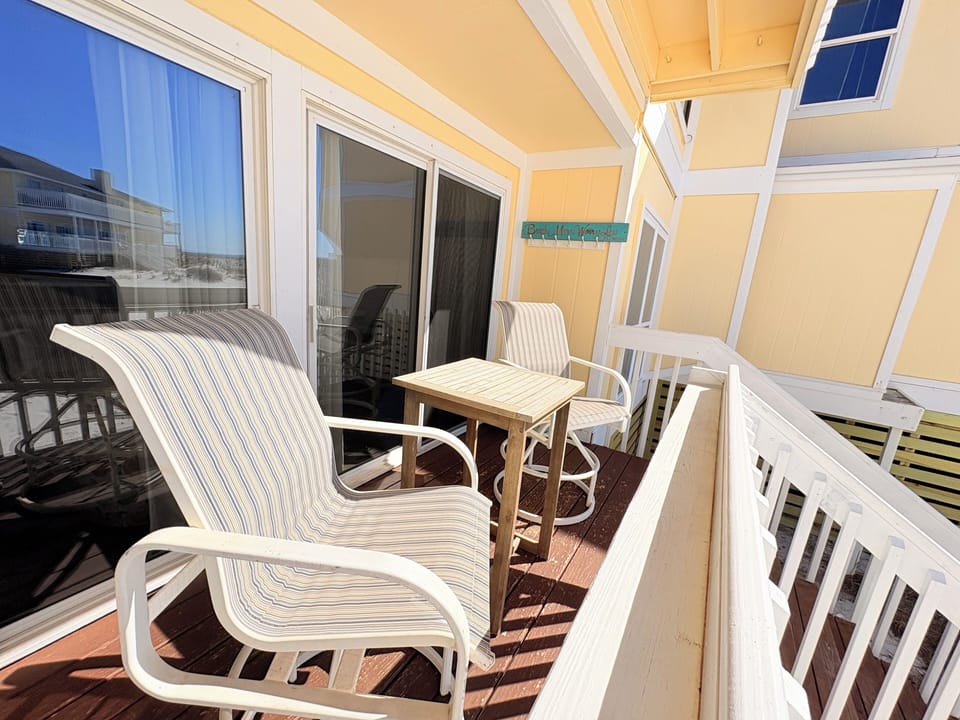 Your private balcony awaits with comfortable seating and a table where you can sip morning coffee while enjoying the peaceful surroundings.