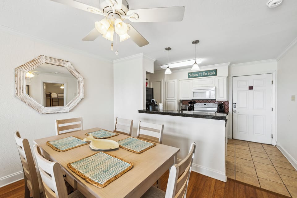 Gather around the table for family meals in your bright, open dining space that flows seamlessly into the fully-equipped kitchen—perfect for creating beachside memories together.