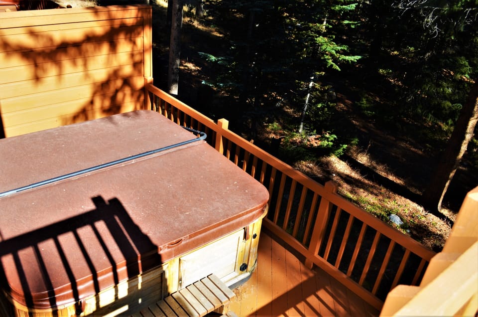 Deck With Private Hot Tub - The second private deck that is accessed through the downstairs level has a private hot tub. The private hot tub overlooks the forest, which gives it a very natural feel.