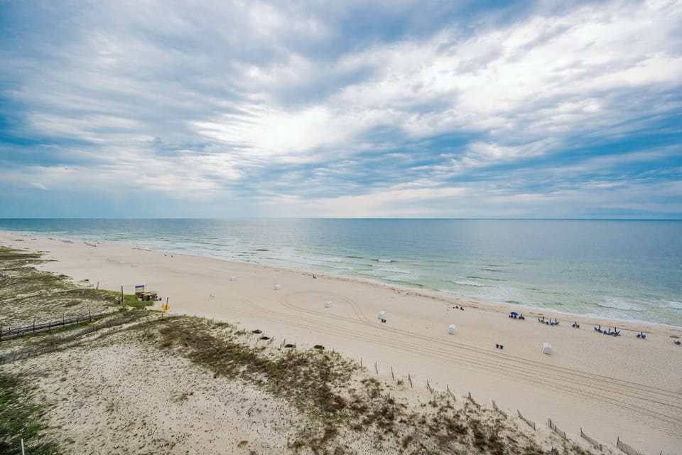 Enjoy the serene view of the shoreline, perfect for relaxation and beachside activities from your balcony