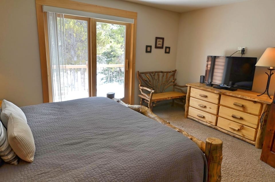 Master Bedroom - This master bedroom is delightful with a view of the Breckenridge Ski Resort, private balcony, King-sized bed, TV, and private bathroom.