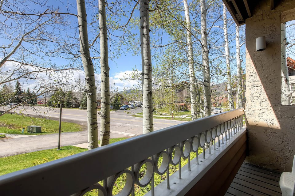 Peaceful neighborhood setting with tree-lined streets and residential area views from the property entrance.