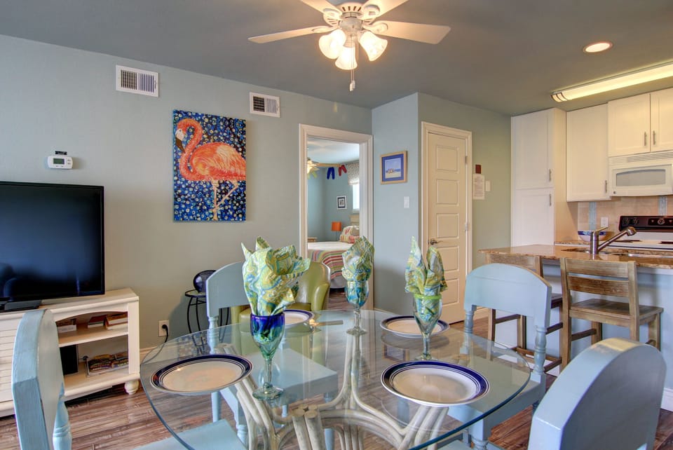 Relax in your bright, open living space with ceiling fan comfort and colorful flamingo art brightening your home away from home.