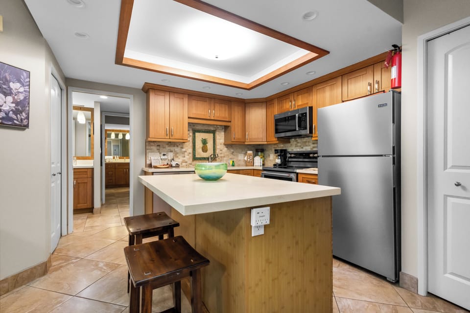 Cook your favorite meals in this fully equipped kitchen with warm wood cabinets, granite counters, and modern appliances.