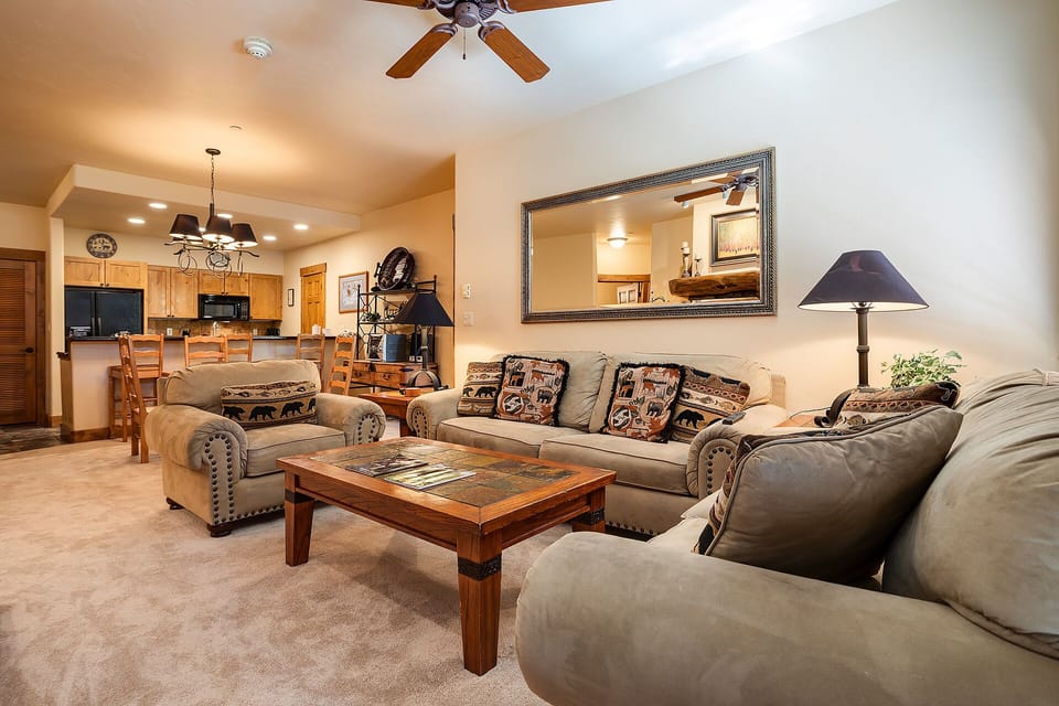 Sink into plush leather seating in your spacious living room, where rustic charm meets modern comfort for memorable evenings together.