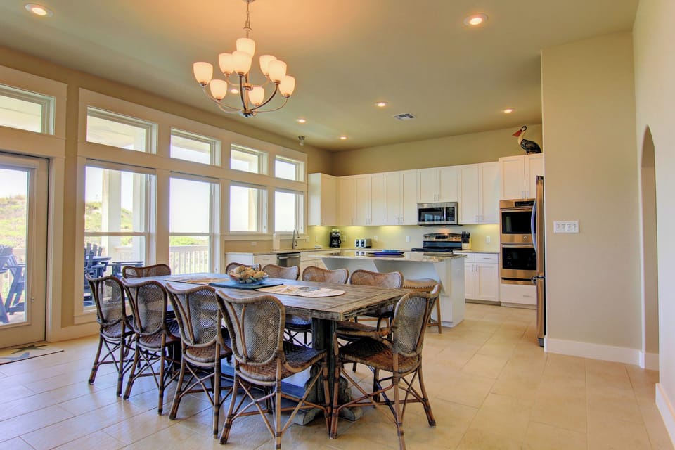 Your open kitchen and dining space features modern appliances and a large table perfect for group meals together.