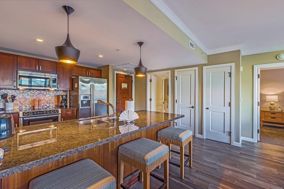 Sleek granite, stainless appliances, and in-unit laundry—everything you need in one stylish Maui kitchen