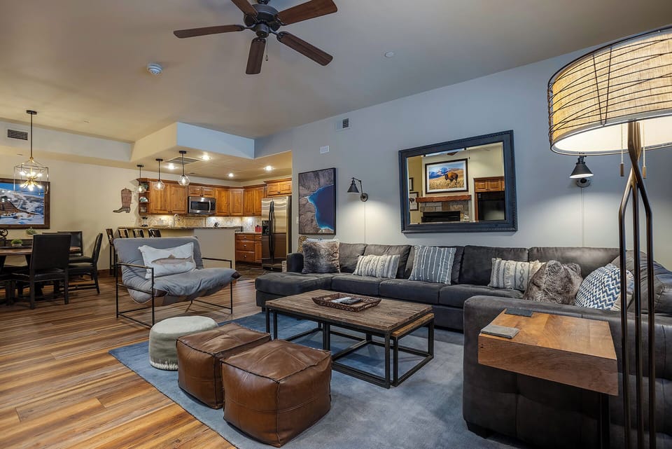 Sink into plush sectional seating where rustic charm meets modern comfort in your spacious open-concept retreat.