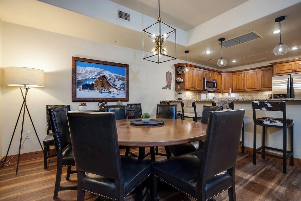 Gather around your elegant dining table for memorable meals, with a gourmet kitchen ready for culinary adventures and warm lighting creating the perfect ambiance.