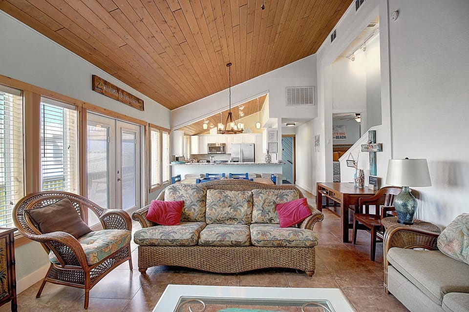 Relax in your spacious living room with soaring wood ceilings, comfortable seating, and an open kitchen perfect for gathering.