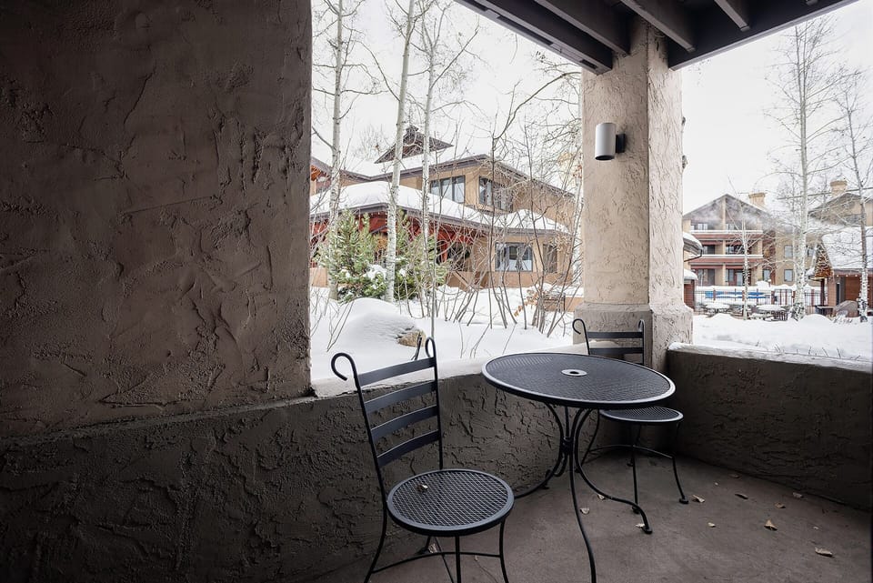 Your private balcony offers a cozy spot to sip morning coffee while watching snow dust the surrounding mountain village.