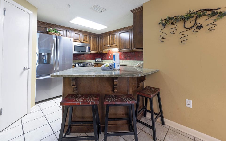 Gather around the stylish kitchen bar area, perfect for casual meals and enjoying drinks together