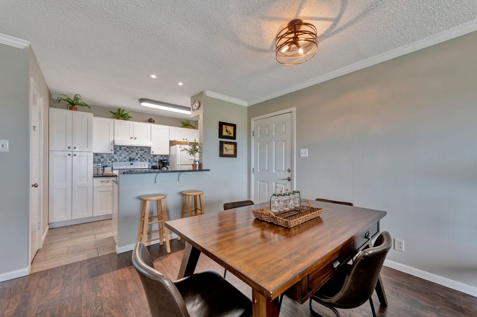 Gather around the warm wood dining table where memories are made over home-cooked meals from your fully equipped kitchen.