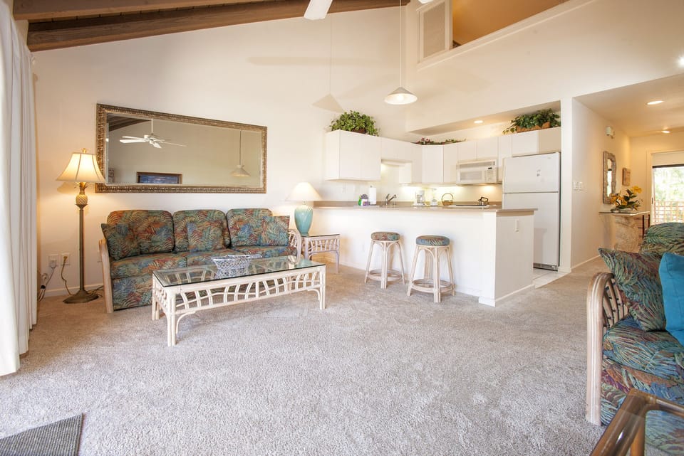 Relax in this bright, open living space with tropical touches and a fully equipped kitchen ready for your island meals.