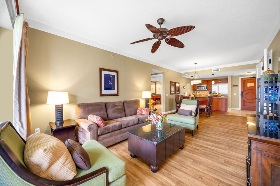 Gather in the open living area with warm wood tones, ample seating, and direct access to outdoor space.