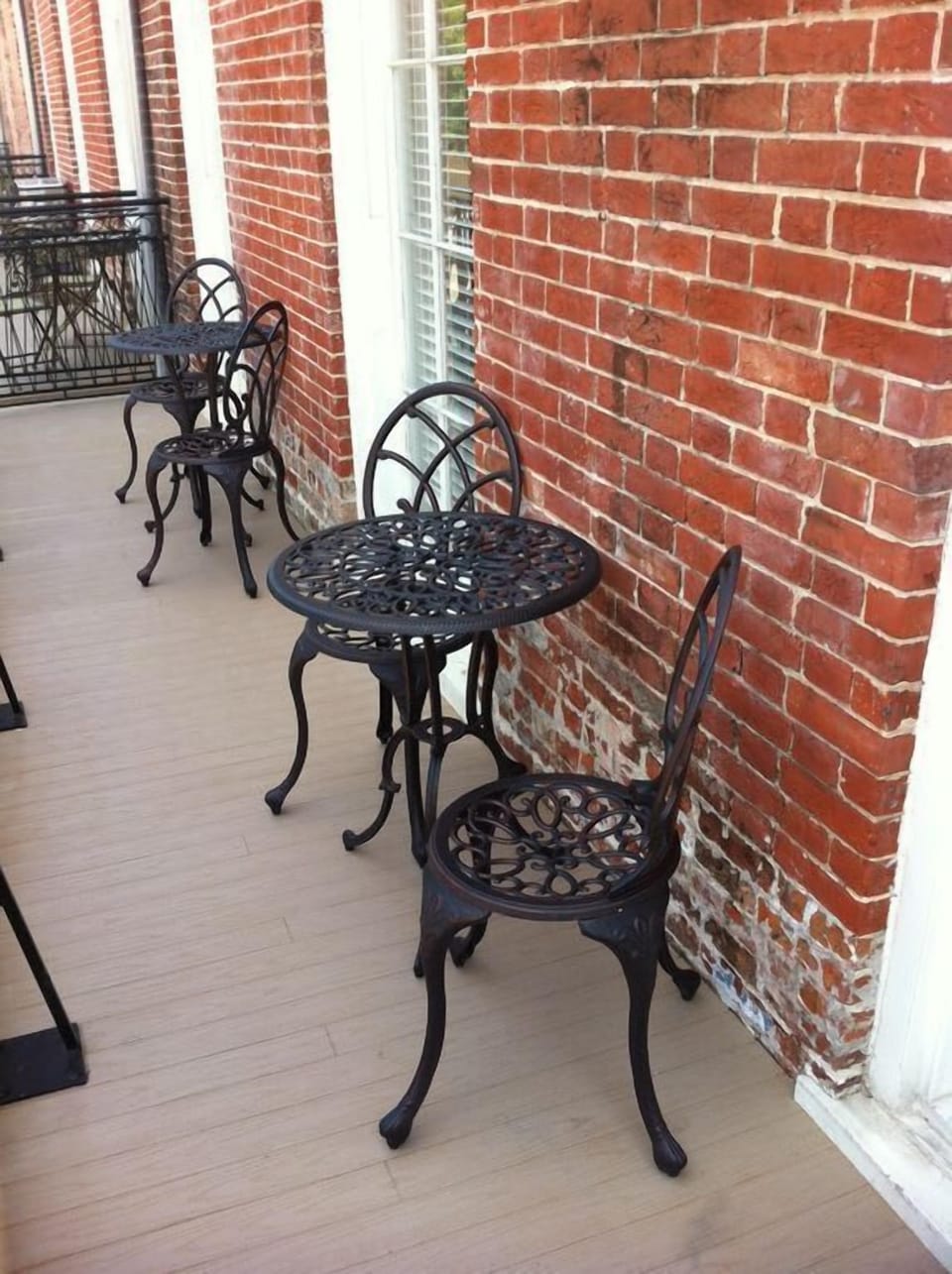 Balcony comes equipped with small wrought iron bistro tables and chairs