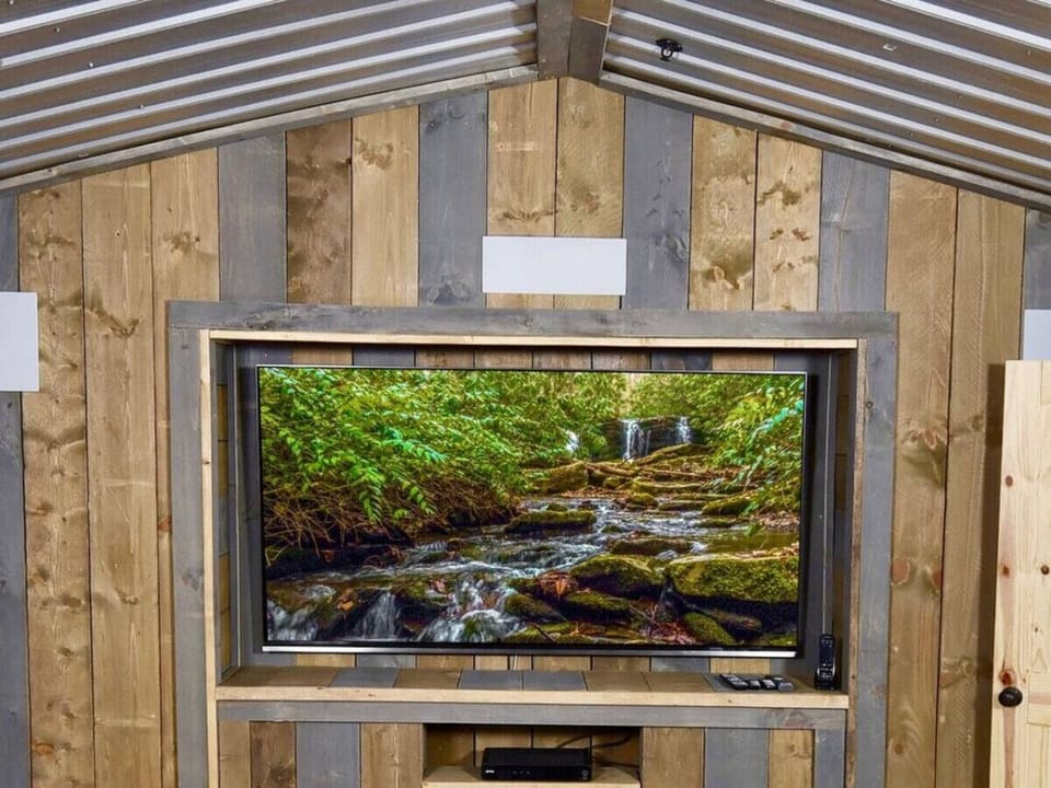 The theater room has a massive 85` 4K TV with surround sound speakers