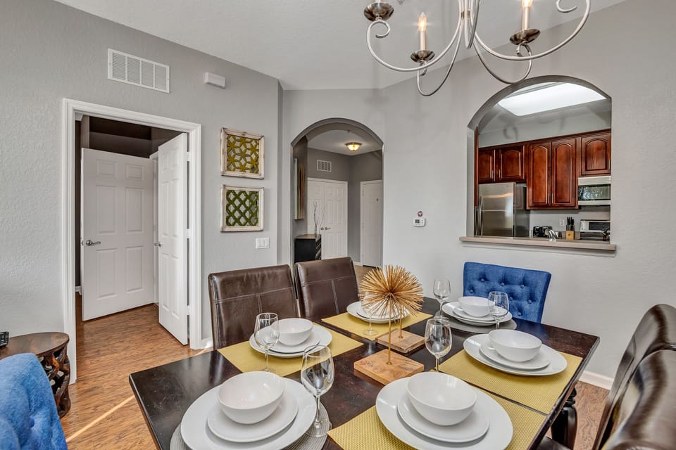 The dining area offers a cozy space for relaxation and shared meals, blending comfort with style. With a beautiful see through window between kitchen and dinning