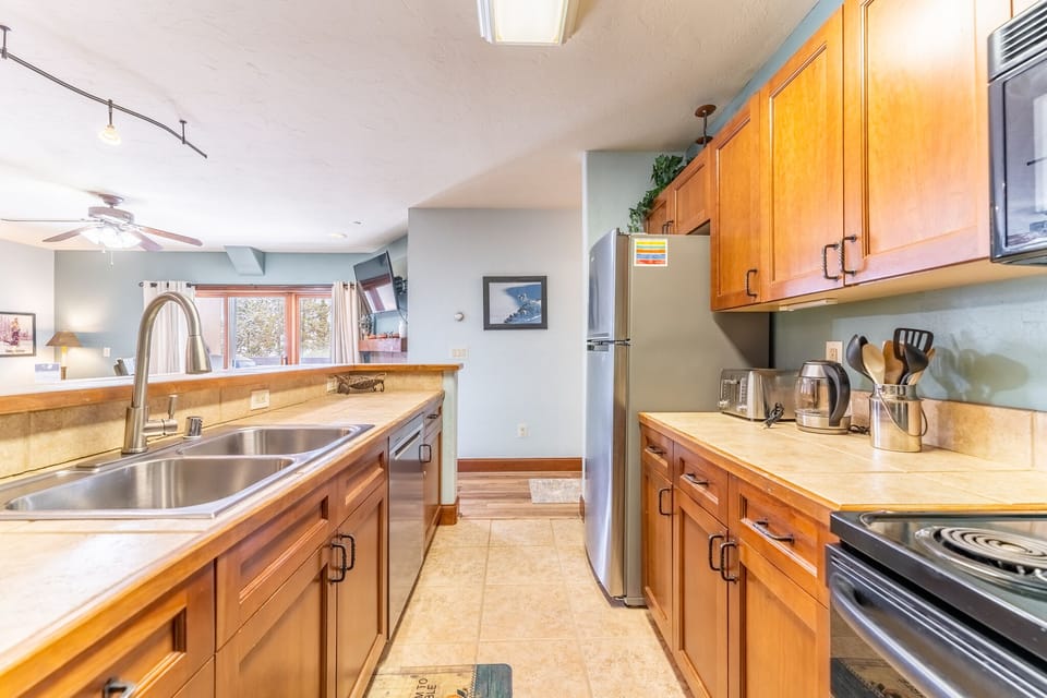 Full size kitchen with stainless steel appliances.