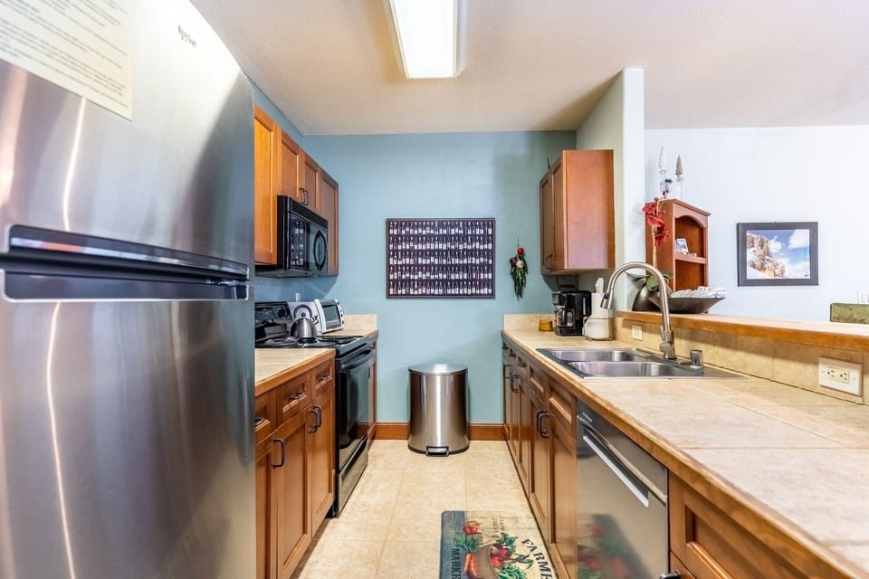 Full size kitchen with stainless steel appliances.