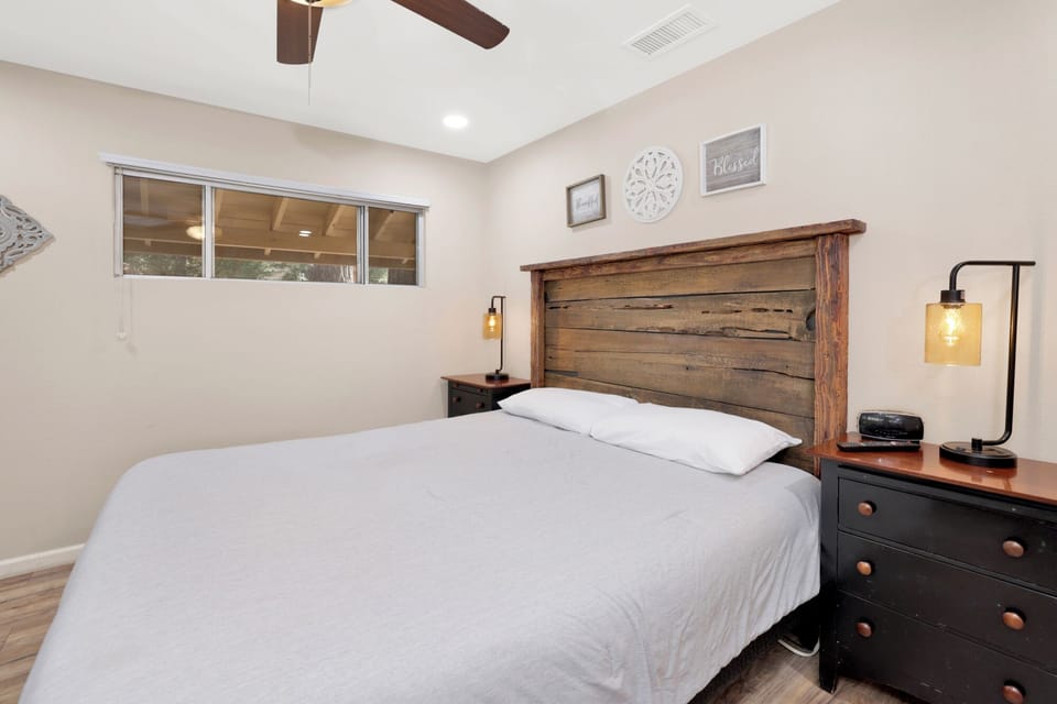 Peaceful cabin bedroom with plush bedding, and beautiful views—ideal for restful nights, cozy mornings, and a relaxing mountain escape.