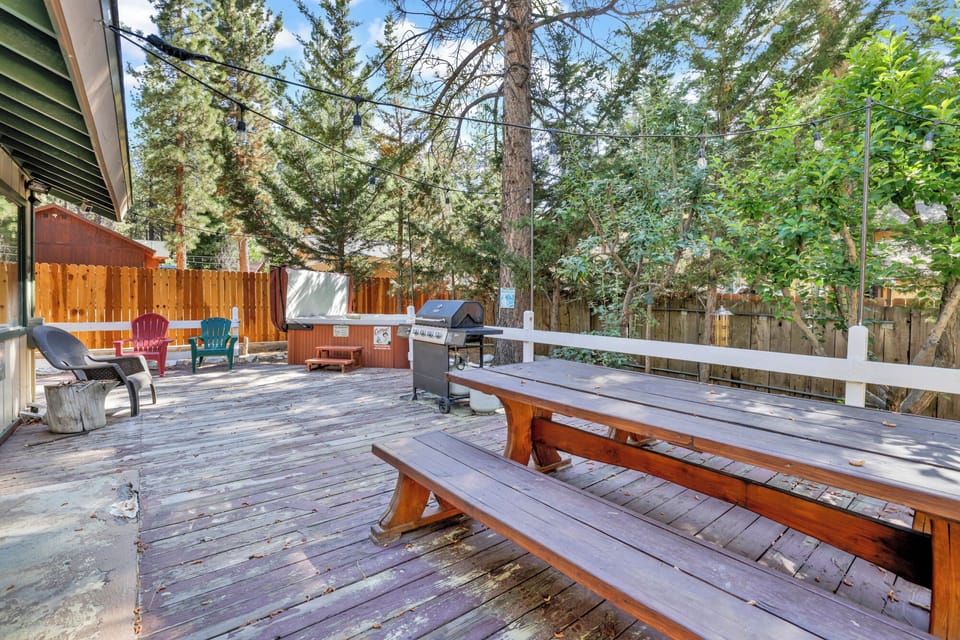 Private outdoor hot tub, surrounded by tall pines, perfect for relaxing under the trees after a day of adventure—enjoy peaceful forest views, fresh air, and a truly rejuvenating stay.