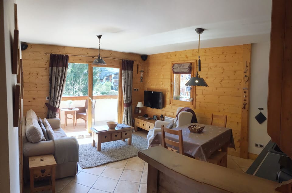 Open plan living area with French doors opening to a South Facing balcony