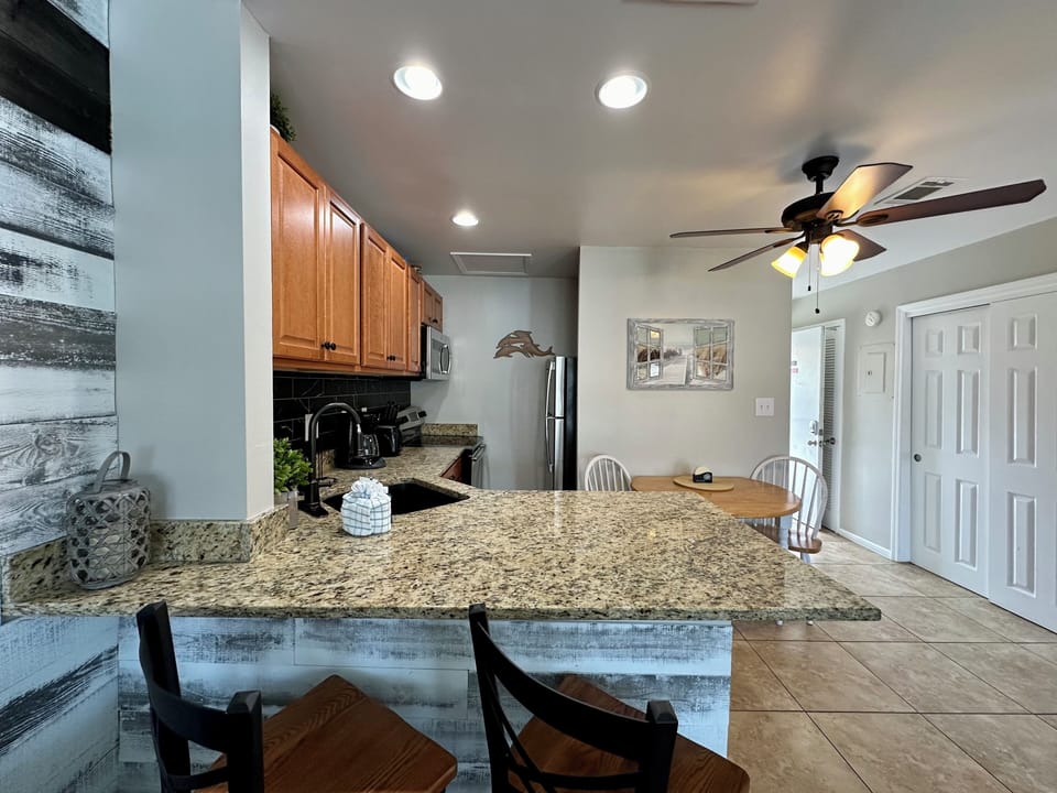 Your fully equipped kitchen offers granite counters and modern appliances, perfect for preparing meals during your stay.