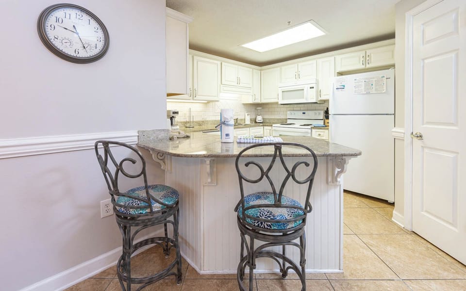 Gather around the stylish bar seating to enjoy meals and conversations in this inviting kitchen space